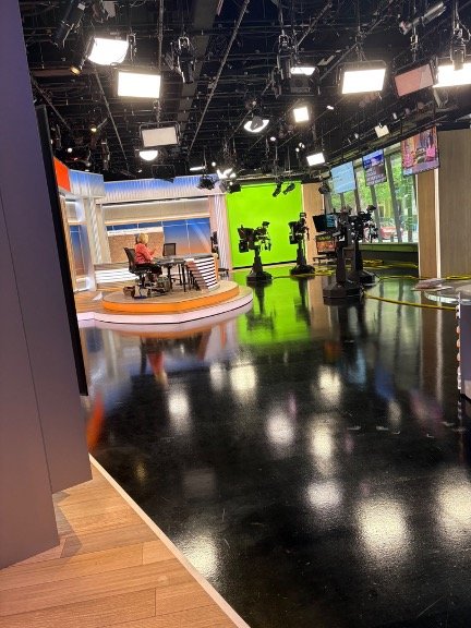 Wide view of CBS Chicago Studio A during LetMeFail media appearance, showing anchors, green screen, and broadcast cameras.
