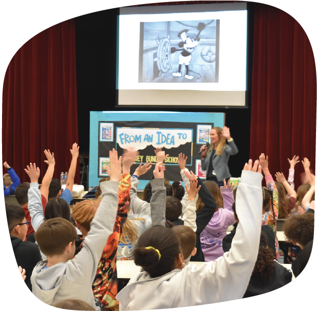 Children raising their hands during an engaging presentation